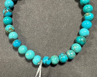 May include: A turquoise gemstone bracelet with a tag that reads "persian 10#"