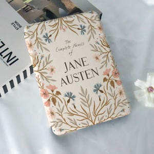 May include: A cream-colored book cover with a floral design in shades of pink, brown, and blue. The text "The Complete Novels of Jane Austen" is printed in brown on the cover.