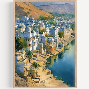 May include: Watercolor painting of a city by a blue river. White buildings with domes and arches line the shore. Palm trees and figures are visible on the sandy bank. A mountain range is in the background, and the painting is framed in a light wood.