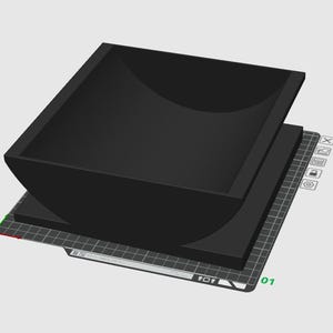 May include: A black, square-shaped container with rounded corners, sitting atop a flat, rectangular base. The container has a curved interior and is displayed on a grid-like surface, suggesting a 3D model or design.