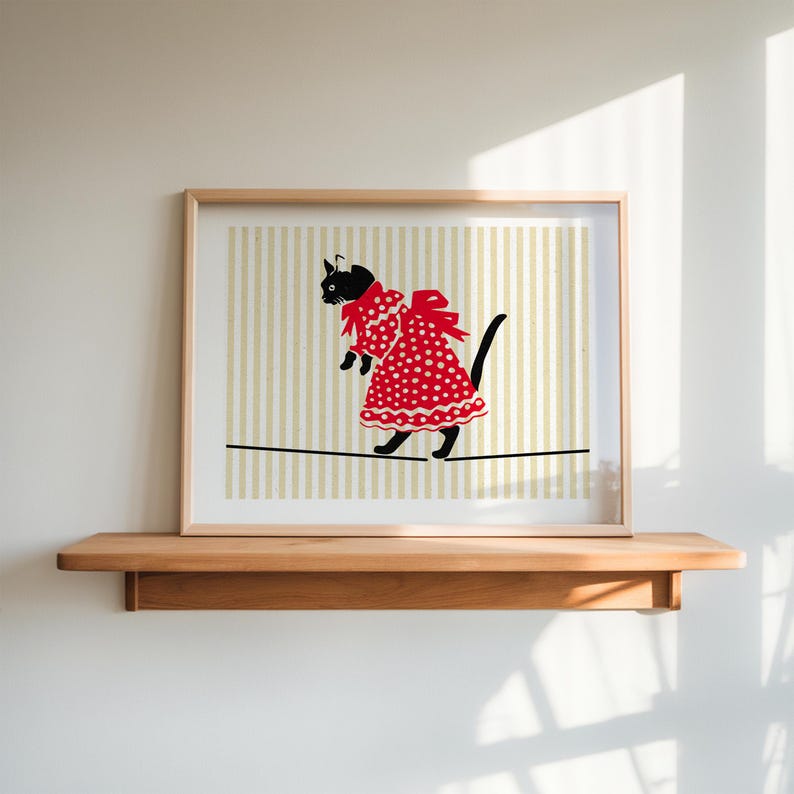 May include: A black cat wearing a red polka dot dress walks on a tightrope. The background is a striped pattern in beige and light brown.