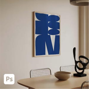 May include: A framed abstract art print featuring bold blue shapes against a white background. The artwork is displayed on a light-colored wall in a dining room setting. A modern, minimalist aesthetic.