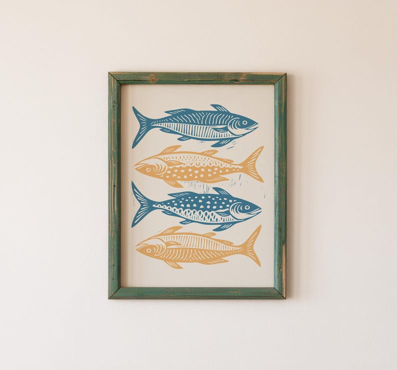 May include: A framed print of four stylized fish in blue and yellow colors. The fish are arranged vertically in a row, with the tails pointing to the right. The print is set against a white background.