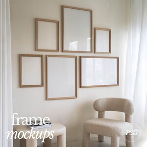 May include: A set of six wooden picture frames in various sizes, arranged on a white wall. The frames are all empty and have a natural wood finish. The frames are arranged in a staggered pattern, with the largest frame at the top and the smallest frame at the bottom. The frames are all hanging on the wall with a white background.