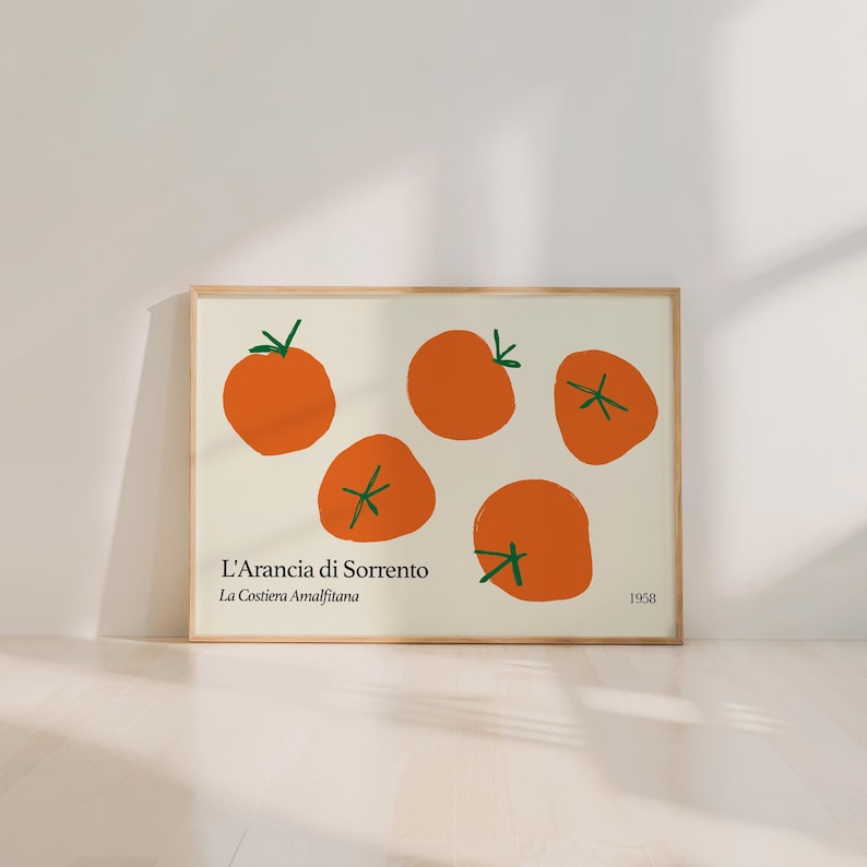 May include: A framed art print featuring orange illustrations of oranges with green stems on a cream background. The text "L'Arancia di Sorrento La Costiera Amalfitana" is below the oranges, with "1958" on the right.