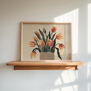 May include: A framed print of a still life featuring a bouquet of orange and yellow tulips in a brown and white striped vase. The tulips are arranged in a vase with green leaves and stems.