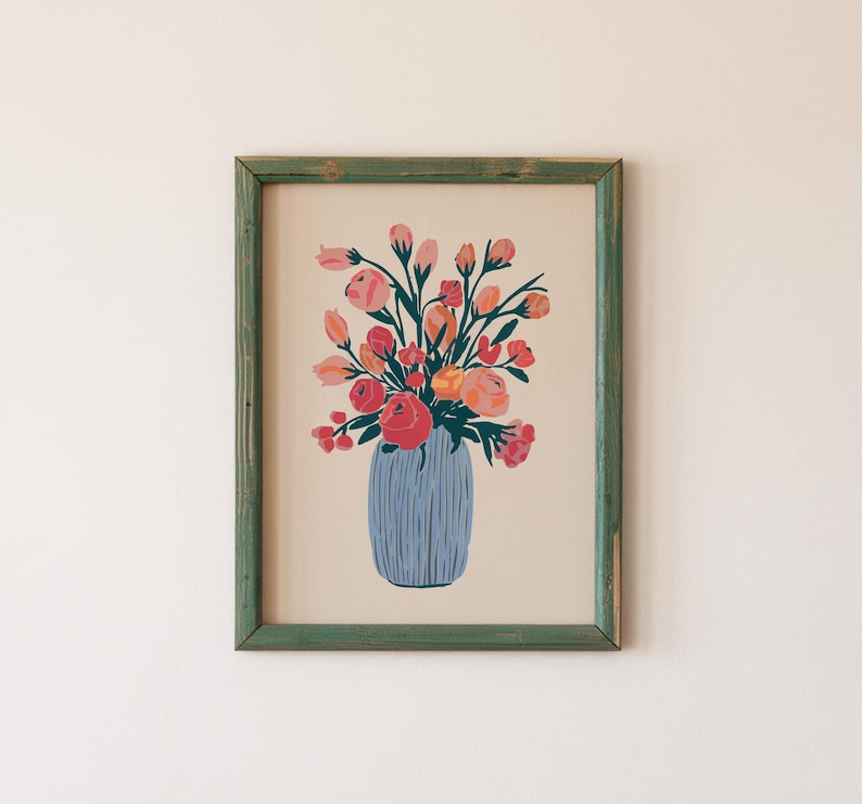 May include: A framed print of a colorful floral arrangement in a blue vase. The flowers are pink, orange, and red, and the vase has a textured pattern.