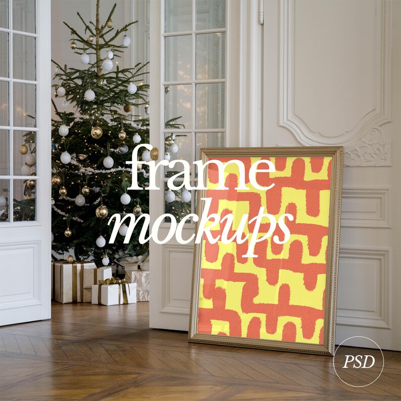 May include: A gold frame mockup with a yellow and orange abstract design inside. The frame is leaning against a white wall in a room with a Christmas tree and presents.