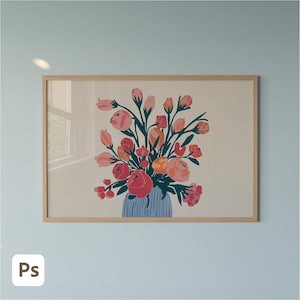 May include: A framed art print depicting a floral arrangement in shades of pink, red, and orange, set in a blue vase. The artwork is set against a light beige backdrop, within a natural wood frame. It's mounted on a light blue wall.