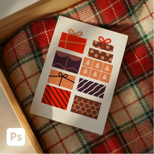 May include: A greeting card featuring a collection of illustrated gift boxes in various colors and patterns. The boxes include red, brown, purple, and orange designs, with bows and stripes. The card is set in a wooden box on a plaid blanket.