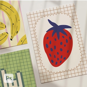 May include: Three colorful art prints featuring fruit illustrations. One print shows yellow bananas with black outlines on a background of pink stripes. Another print displays a red strawberry with blue seeds and a blue stem. The third print has a green grid pattern.