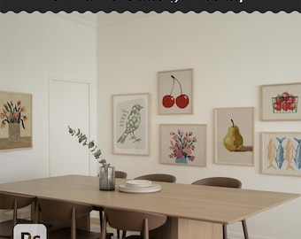 Peut inclure: Maquette de galerie de 8 cadres présentant des impressions d'art encadrées avec des illustrations botaniques et de fruits. Les impressions comprennent des images de cerises, de fleurs, d'une poire et de poissons. Une longue table en bois avec des chaises est au premier plan.