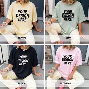 May include: Four oversized t-shirts in butter, bay, black, and blossom colors. Each shirt features the text "YOUR DESIGN HERE" in a bold, black font. The shirts are paired with light-colored pants.