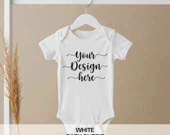 May include: White baby onesie mockup with the text "Your Design Here" in black cursive font.