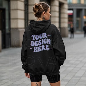 May include: Black hooded sweatshirt with a purple and blue graphic that says "YOUR DESIGN HERE" on the back.
