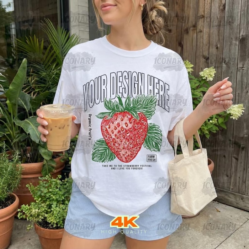 May include: White t-shirt featuring a red strawberry design with green leaves and the text "YOUR DESIGN HERE". The shirt also has the text "Take me to the strawberry festival and I love you forever!" and "Farm Fresh".