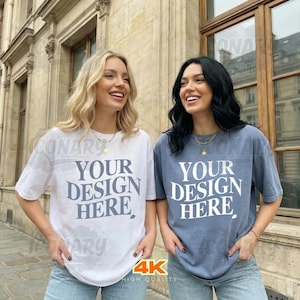 May include: Two people wearing white and blue t-shirts with the text "YOUR DESIGN HERE" in a bold, sans-serif font. The white shirt is paired with light blue jeans, while the blue shirt is paired with light blue jeans. The image is labeled "4K High Quality".