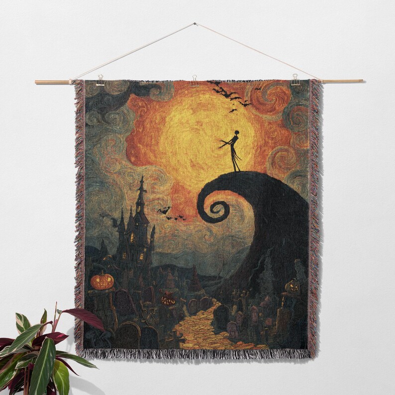 May include: A woven tapestry featuring a scene from "The Nightmare Before Christmas." The artwork depicts Jack Skellington on a hill, a spooky town, and a large orange moon. The tapestry is hung with a wooden rod.