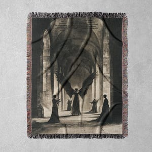 May include: A tapestry featuring a black and white illustration of an angel with wings spread wide, standing in a cathedral with four figures in the foreground. The angel is in the center of the image, and the figures are on either side of the angel. The tapestry has a fringe border.