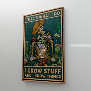 May include: A framed poster featuring a skeleton wearing a straw hat and surrounded by cacti and flowers. The text at the top reads "THAT'S WHAT I DO" and the text at the bottom reads "I GROW STUFF AND I KNOW THINGS."