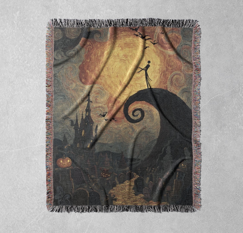 May include: Woven throw blanket featuring a spooky scene with a silhouetted figure on a hill, a swirling spiral, and a haunted house. The color palette includes shades of orange, yellow, and black, with a fringed edge.