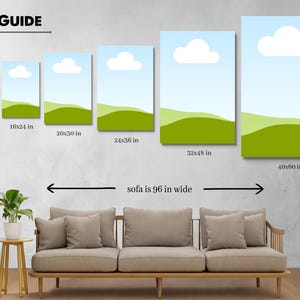 Op de afbeelding: Een maattabel toont zes canvas prints met een landschapsontwerp van een blauwe lucht, witte wolk en groene heuvels. De maten zijn 30x46 cm, 41x61 cm, 51x76 cm, 61x91 cm, 81x122 cm en 102x152 cm. Een bank is eronder afgebeeld.