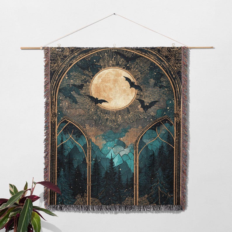 May include: A woven wall tapestry featuring a moonlit forest scene with bats. The artwork has a gothic aesthetic, with a large full moon, dark green trees, and a teal and gold color palette. The tapestry is hung from a wooden rod.