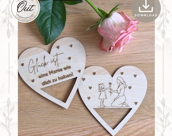 May include: Two wooden heart-shaped ornaments with a laser-cut design. The larger heart has the text "Glück ist... eine Mama wie dich zu haben!" The smaller heart has a laser-cut design of a mother and daughter holding flowers.