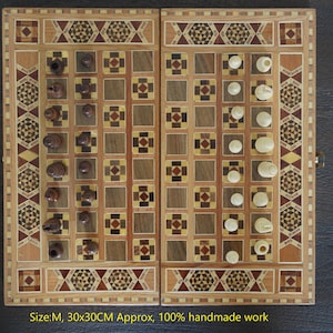 May include: A wooden backgammon board with inlaid wood designs. The board is closed and has a light brown finish. The board is 30 inches by 30 inches and is 100% handmade.