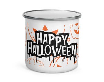 May include: White enamel mug with a silver rim, featuring the words "HAPPY HALLOWEEN" in a black, dripping font. Orange pumpkin and decorative accents are scattered around the mug, creating a festive Halloween theme.