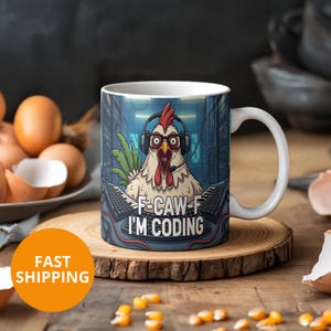 May include: White ceramic mug featuring a cartoon chicken wearing headphones and glasses, with the text "F-CAW-F I'M CODING". The mug is on a wooden coaster. The background shows a server room.