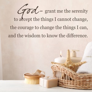May include: A wicker basket filled with a white towel, a candle, a bottle of lotion, and a starfish. The basket is sitting on a white surface. The text "God - grant me the serenity to accept the things I cannot change, the courage to change the things I can, and the wisdom to know the difference." is written on the wall behind the basket.