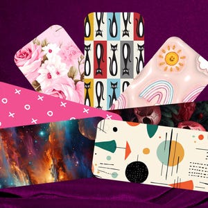 May include: Assortment of phone cases with various designs, including a pink floral pattern, a black and white cat pattern, a pink rainbow pattern, a pink and white cross pattern, a galaxy pattern, and a retro abstract pattern.