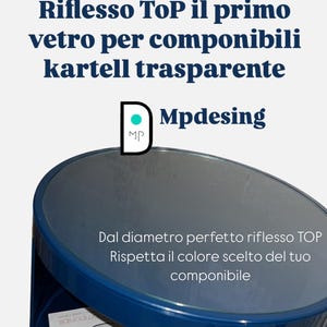 May include: A dark blue, round-topped Kartell side table with a reflective surface. The table has a cylindrical base and a small opening. Text on the table reads "Riflesso TOP" and "Mpdesing".