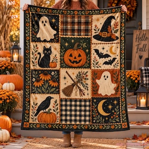 May include: A rectangular throw blanket featuring a grid of nine panels with Halloween imagery including a ghost, a black cat, a jack-o'-lantern, a witch hat, bats, a broom, flowers, a crow, and a crescent moon, accented by plaid patterns.