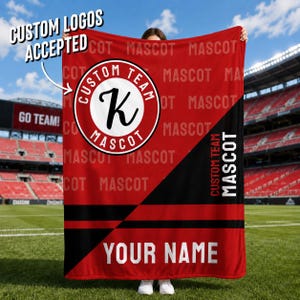 May include: A red and black blanket with the text "CUSTOM LOGOS ACCEPTED" and "YOUR NAME". The blanket features a circular logo with the letter "K" and the words "CUSTOM TEAM MASCOT". The background has the word "MASCOT" repeated.