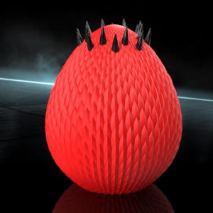 May include: A red, spiky ball with black spikes on top. The ball has a textured surface.