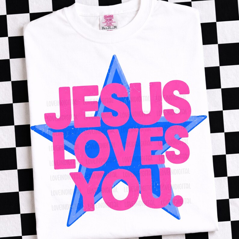 May include: White t-shirt with a blue star and the text "JESUS LOVES YOU" in pink. The shirt has a crew neck and short sleeves. The shirt is made of a soft, comfortable material.