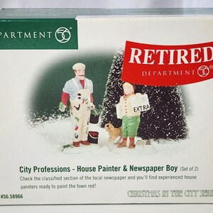 May include: A Department 56 City Professions set featuring a house painter in white overalls with paint splatters and a newspaper boy holding a paper that says EXTRA. The box includes a small dog figure and the text Christmas in the City Series.