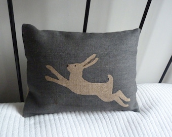 Hand printed muted midnight blue little leaping logo  hare cushion cover
