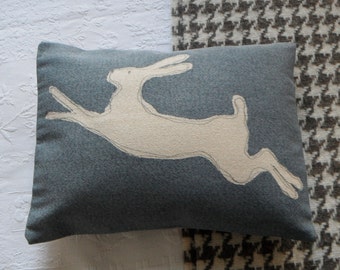 hand printed muted blue leaping hare cushion cover