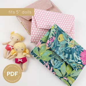 May include: Three fabric doll purses in pink, floral, and polka dot patterns, with two small dolls wearing red shorts. The text "fits 5" dolls" is above the purses. A round logo with the text "PDF" and "sewing pattern and tutorial" is in the lower left corner.