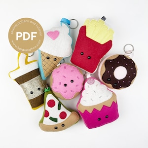 May include: A set of nine felt food keychain charms, including a donut, ice cream cone, cupcake, pizza slice, french fries, coffee cup, and two different types of cake. The charms are all brightly colored and have cute faces.