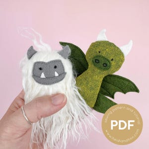 May include: Two plush toys, one white shaggy creature with gray felt face details and two small horns, and one green textured dragon with white horns and dark green wings. A circular graphic includes the text PDF sewing pattern and tutorial.