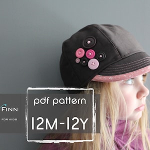 May include: A brown and pink patterned newsboy cap with buttons. The cap is for children and has a pdf pattern for sizes 12 months to 12 years. The text "pdf pattern 12M-12Y" is on a white background.