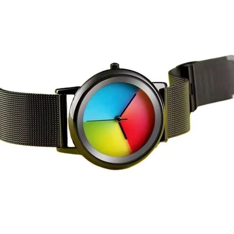 May include: A black wristwatch with a colorful face divided into four sections: blue, red, yellow, and green. The watch has a black metal mesh band. The watch face has black hands and a black bezel.