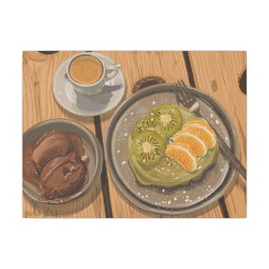 May include: A plate of green pancakes topped with kiwi slices and orange segments. A small cup of coffee and a bowl of chocolate sauce are also on the table.