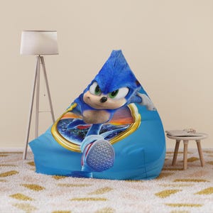 May include: Blue bean bag chair featuring a printed image of Sonic the Hedgehog from the movie Sonic the Hedgehog 2. Sonic is running and has a determined expression on his face.