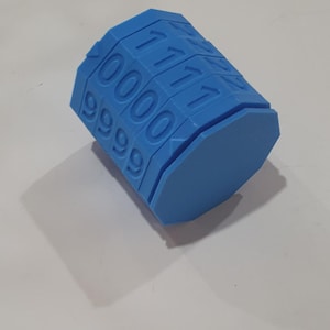May include: A blue plastic combination lock with four rotating dials, each numbered 0-9. The lock is in the shape of a cylinder with a hexagonal base.