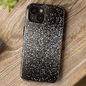 May include: Black phone case with a white speckled design.